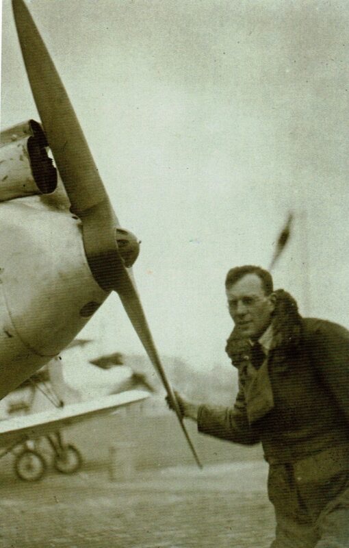 Francis Chichester in flying gear, turning the propeller of his Gypsy Moth biplane